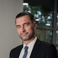 Man with a suit looking into the camera